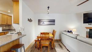 a kitchen and living room with a table and a couch at Payette Pines Hideaway in McCall +16 photos
