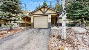 a house with a garage and a driveway at Payette Pines Hideaway in McCall