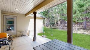 a screened in porch with a table and chairs at Payette Pines Hideaway in McCall