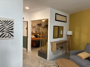 a living room with a bed and a couch at ALMOHADES del JERTE in Galisteo
