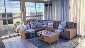 a living room with a couch and a coffee table at Protea House - self-catering house with a Pool in Durban