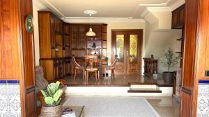 a dining room and kitchen with a table and chairs at la Casa de Flores in Tossa de Mar