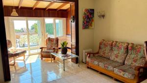 a living room with a couch and chairs and a table at la Casa de Flores in Tossa de Mar
