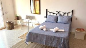 a bedroom with a bed with two stuffed animals on it at la Casa de Flores in Tossa de Mar