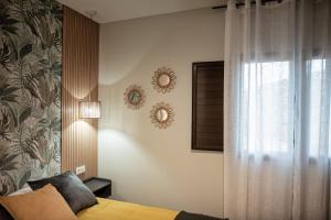 a bedroom with a bed and a window at ALMOHADES del JERTE in Galisteo