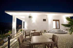 a table and chairs on a patio at night at Çifliku RSXH in Gjirokastër