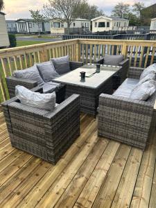 a patio with wicker chairs and a table on a deck at Nickys happy place in Greencastle