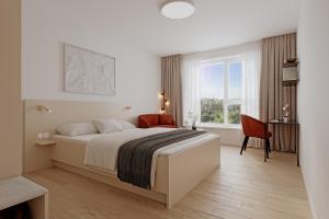 a bedroom with a large bed and a window at Boardinghouse Air Tech Campus - smart Check-in in Weßling