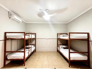 two bunk beds in a room with a ceiling fan at Hostel Diniz in Vitória