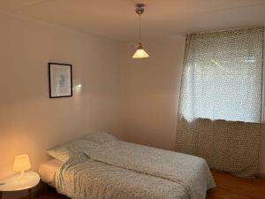 a bedroom with a bed and a window at Hus in Risskov