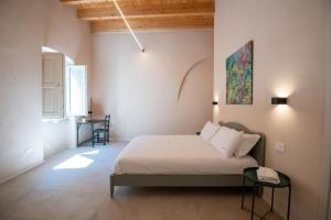 a bedroom with a bed and a table in it at Borgo Puglia in Bisceglie