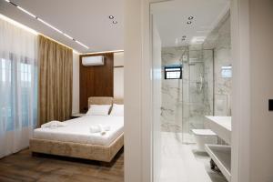 a bedroom with a bed and a bathroom with a shower at Çifliku RSXH in Gjirokastër +91 photos