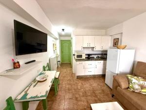 a small living room with a couch and a kitchen at Luis Vives in Benalmádena