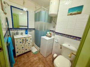 a bathroom with a toilet and a sink at Luis Vives in Benalmádena +4 photos