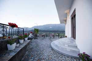 a group of stairs on a building with flowers at Çifliku RSXH in Gjirokastër