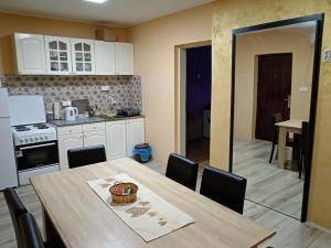 a kitchen and dining room with a table and chairs at Tiski raj in Bečej