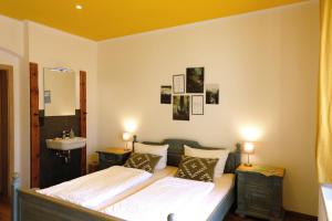 a bedroom with two twin beds and a sink at Villa Lydia in Kurort Altenberg