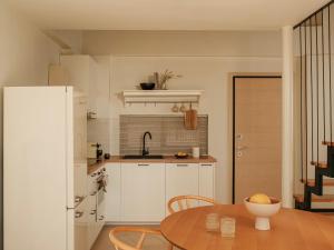 a kitchen with a table and a sink and a refrigerator at springs suites no4 in Kato Alepochori +54 photos