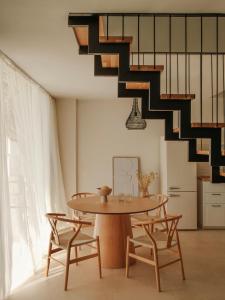 a dining room with a table and a staircase at springs suites no4 in Kato Alepochori