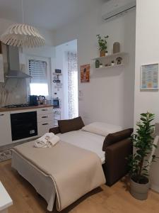a room with a bed and a couch and a kitchen at Dolce Vita in Bari