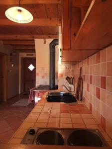 a kitchen with a sink and a stove at Holiday Home Brist in Brestova Draga