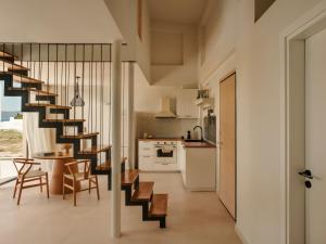 a kitchen and dining room with a spiral staircase in a house at springs suites no4 in Kato Alepochori