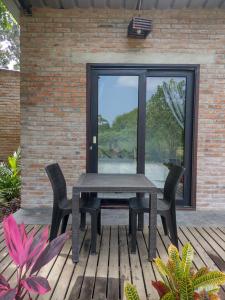 a table and chairs on a wooden deck at Rio Olón ecolodge in Olón +18 photos