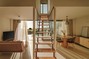a living room with a spiral staircase in a house at springs suites no4 in Kato Alepochori