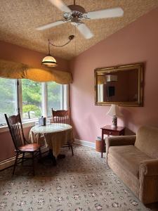 a living room with a table and a couch at Sylvan Inn Bed & Breakfast in Glen Arbor