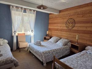 a bedroom with two beds and a window at Le Guilazur in Château-Ville-Vieille