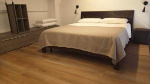 a bedroom with a large bed and a wooden floor at NaturalmenteLucia in Cologno al Serio