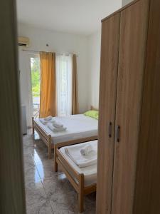 a room with two beds and a closet at Long Beach Truma in Ulcinj