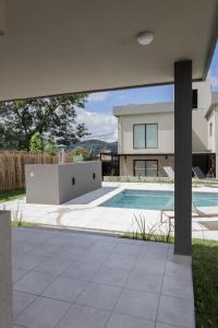a swimming pool in front of a house at Almería Suites in Salta