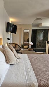 a bedroom with a large bed with white sheets and pillows at QUIRICO GUEST HOUSE in Locorotondo