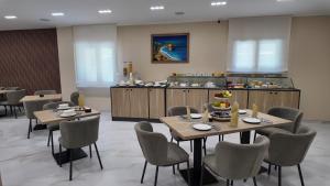 a restaurant with tables and chairs and a buffet at Airfield Hotel & Spa in Vibo Valentia +76 photos