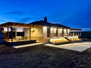 a house with a porch with chairs on it at Anatèlia Beach House in Portianón