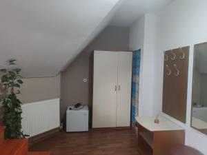 a attic room with a white cabinet and a sink at Siesta Pension in Miercurea-Ciuc +61 photos