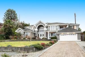 a large white house with a driveway at Island Time Escape in Saratoga Shores