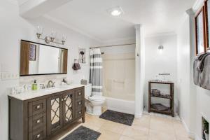 a bathroom with a sink and a toilet and a tub at Island Time Escape in Saratoga Shores +45 photos