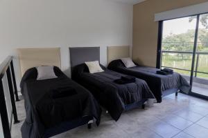 a room with two beds and a window at Almería Suites in Salta +51 photos