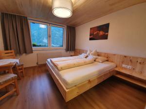 a bedroom with a large bed in a room at Ferienhaus Tirolerhof in Kals am Großglockner