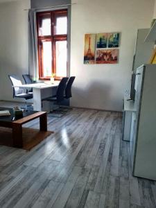 an empty room with a table and chairs and a desk at Gold Apartment - Győr in Győr