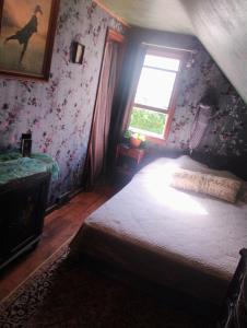 a bedroom with a bed and a window at Magical stone cottage in Pine Grove Mills