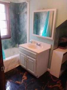 a bathroom with a sink and a bath tub at Magical stone cottage in Pine Grove Mills +6 photos