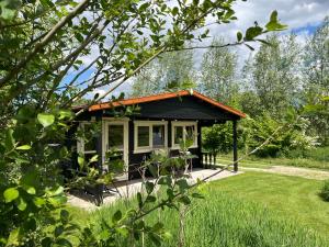 a small house with an orange roof in a garden at Fields 1216 in Zwaanshoek