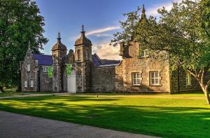 an old stone building with a green lawn in front of it at The Loft in Cookstown Junction