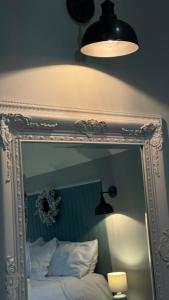 a mirror above a bed in a bedroom at The Loft in Cookstown Junction