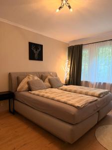 a large bed in a room with a window at LevelUp Comfort in Koblenz