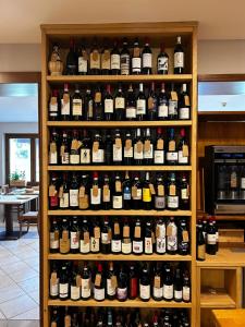a shelf filled with lots of bottles of wine at Locanda Fungo Reale in Valloriate