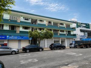 a building with cars parked in front of it at Ap Umarizal l WiFi 500MB in Belém